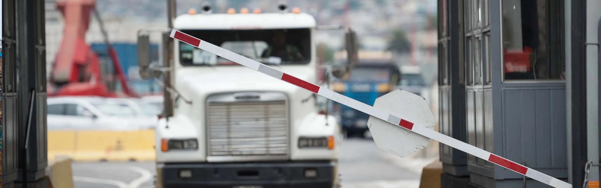 Semi-truck passing through a weigh station checkpoint gate
