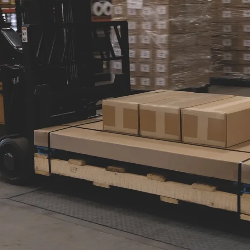 Close-up of a forklift scale carriage lifting boxes in a warehouse